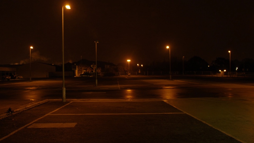 Scout frame: an empty car park under sodium light