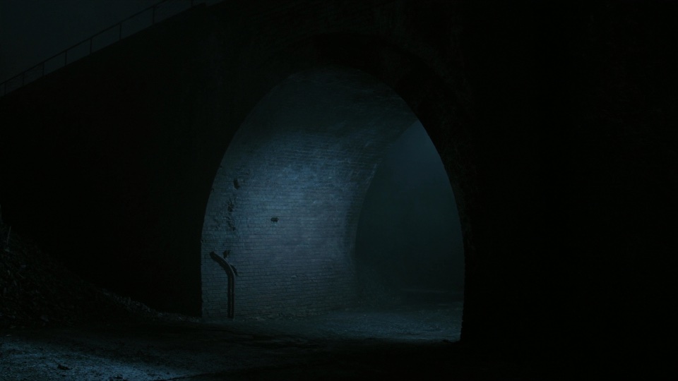 Scout frame: mist under a brick viaduct arch